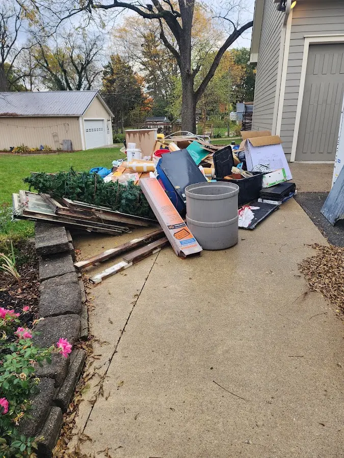 Dumpster being loaded with debris for 10 Yard Dumpster Rental in Greeley